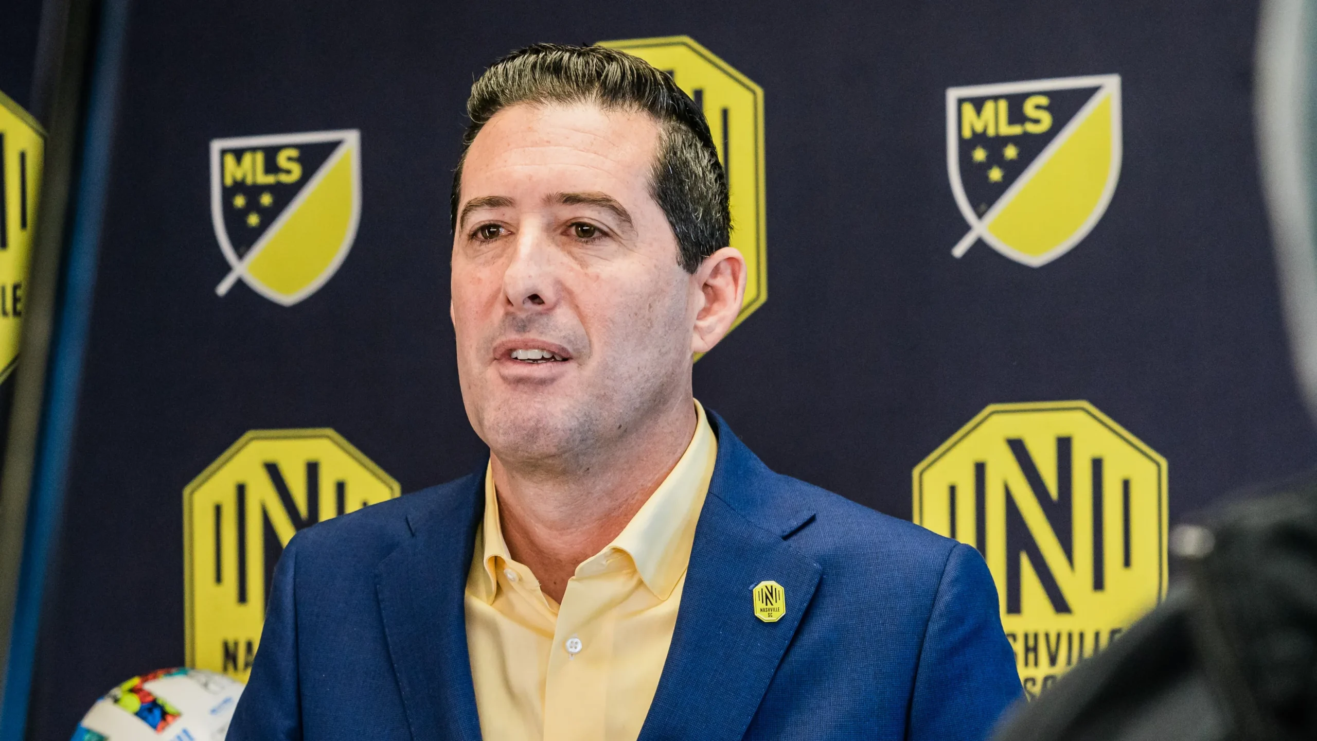26d6d5a3-0a02-453d-85f5-252727e62636-PHOTO_-_Nashville_SC_GM_Mike_Jacobs_Selects_Ahmed_Longmire_-_2022_MLS_SuperDraft_-_10th_Pick_Original_Image_m59502